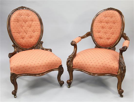 A pair of Victorian walnut ladys and gentlemans armchairs,